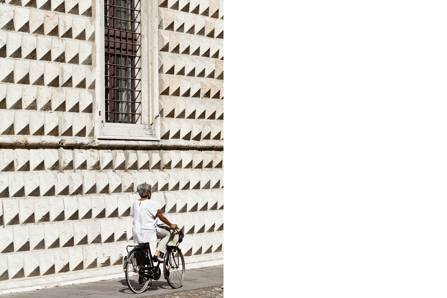 A cyclist passes the Palazzo dei Diamanti Ferrara Emilia-Romagna Italy Built 1493 to 1503